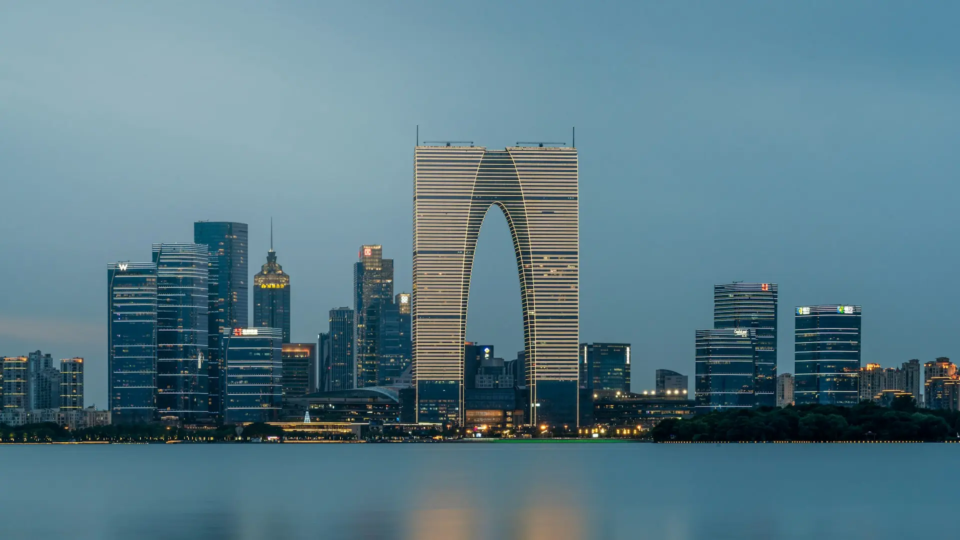 a city skyline with skyscrapers and a body of water